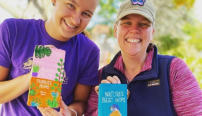 volunteers at the installation of the Fowler Pollinator Garden banner